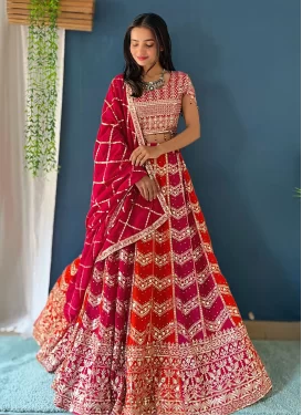 Georgette Trendy Lehenga Choli with Embroidered Work in Crimson and Orange for Festival