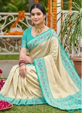 Jacquard Silk Trendy Saree with Woven Work in Cream and Firozi