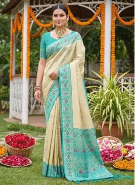 Jacquard Silk Trendy Saree with Woven Work in Cream and Firozi